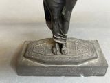 a statue of a woman standing on top of a box