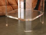 a clear table with a glass top on the floor