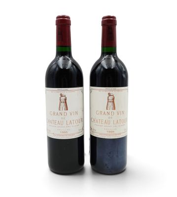 two bottles of wine that are sitting next to each other