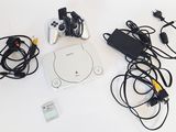 a video game console and other electronics on a table