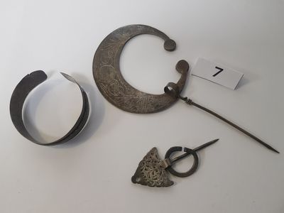 a pair of scissors and a pair of scissors next to a piece of metal