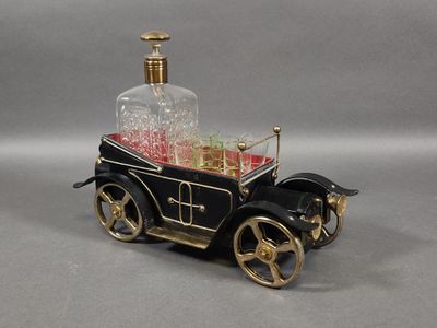 a miniature model of a car with a bottle on top of it