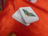 a white container with a design on it on a table