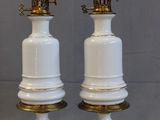 two white lamps that are sitting on a table
