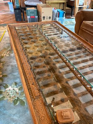 a coffee table with a glass top on a living room floor