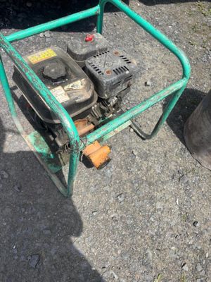 a green cart that has a small engine on it