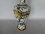 a vase with a fish on it sitting on a table