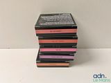 a close up of a stack of four boxes of lipstick