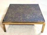 a close up of a coffee table with a blue top and gold legs
