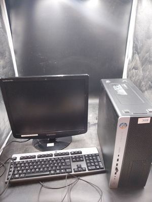 un ordinateur de bureau posé à côté d'un clavier et d'un écran