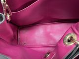 a close up of a pink purse with a gold handle