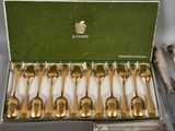 six spoons in a box on a table