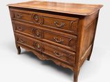 a wooden chest of drawers with ornate carvings on the drawers