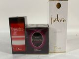 two boxes of perfume sitting next to each other on a white surface