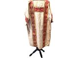 a white and red dress on a mannequin stand