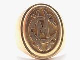 an image of a gold ring with a monogrammed m on it