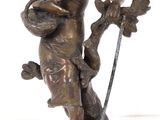 statue en bronze représentant une femme tenant une épée et un oiseau, posée sur un socle