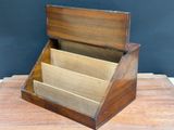 a wooden box with three compartments sitting on a table