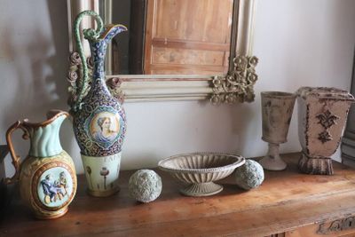 many vases and bowls sitting on a wooden table