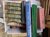 a stack of books sitting on top of a wooden table