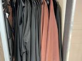 a lot of clothes hanging on a rack in a closet