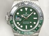 a rolex watch with a green dial on a bracelet