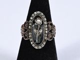 a close up of a silver ring with a flower on it