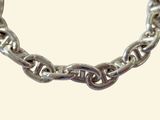 a close up of a silver chain bracelet on a white background