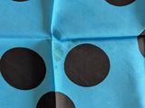 blue and black polka dot fabric with brown spots on it