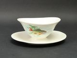 a white saucer with a fish on it on a saucer