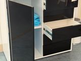 a black and white cabinet with drawers and a printer