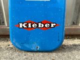 a blue suitcase with a sticker that says kieber on it