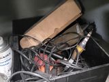 a black box filled with assorted items on top of a shelf