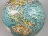 a small globe on a stand with a map on it