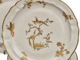 three plates with gold and white designs on them