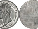 a close up of a silver coin with a face of a man on it