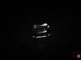 a close up of a ring in the dark with a light shining on it
