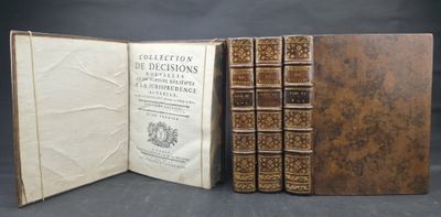 three books are stacked on top of each other on a table