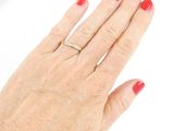 an image of a woman ' s hand with a red manicure holding a diamond ring