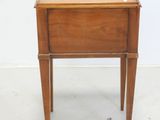 a small wooden table with a drawer on top of it