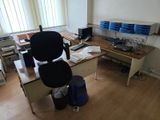 a desk with a chair and a computer on it