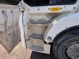 a white truck with its door open on the side of the road