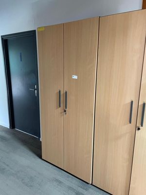 a room with a lot of cupboards and a door