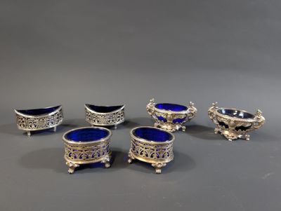 four silver and blue glass dishes on stands