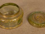 a small glass jar with a lid on a table