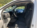 the interior of a car with the door open and the driver ' s seat down