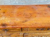 an old wooden dresser with two drawers on top of it