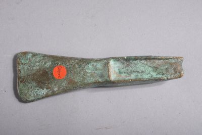 a small metal object with a red dot on it