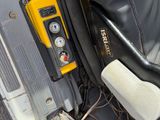 a seat in the back of a car with a remote control