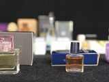 several bottles of perfume sitting on top of a table next to each other